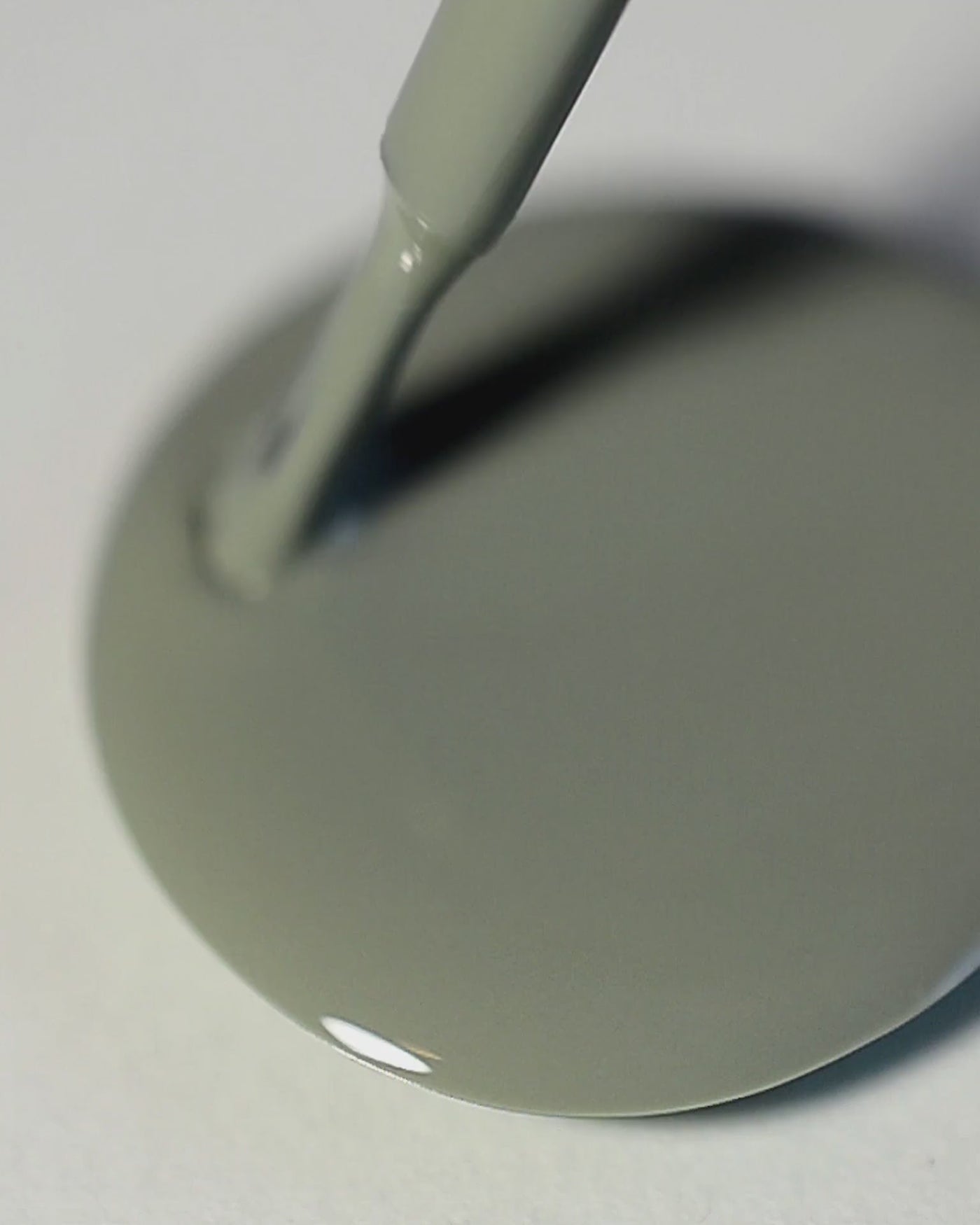 A nail polish swirl of Soundscape sage green crème by Sienna Byron Bay close-up.