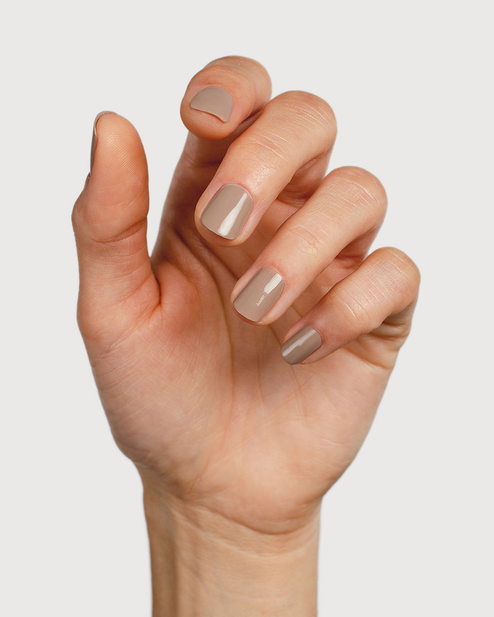 Warm clay nail polish hand swatch on fair skin tone