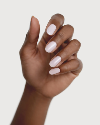 misty lilac nail polish hand swatch on medium skin tone