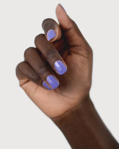 Gentle Midtone Blue Lilac Crème nail polish by Sienna Byron Bay on dark skin tone hand.