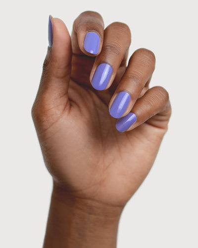 Gentle Midtone Blue Lilac Crème nail polish by Sienna Byron Bay on medium skin tone hand.