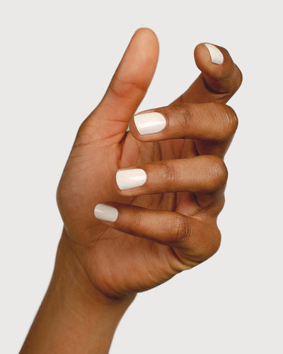 offwhite nail polish hand swatch on medium skin tone