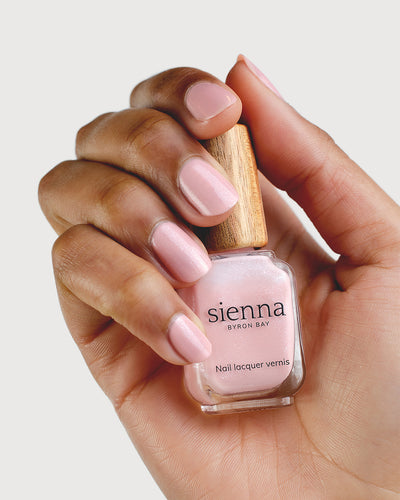 Shimmering Cherry Blossom Nail Polish on Medium Skin Tone with Sienna Bottle
