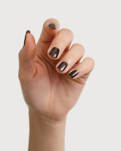 chocolate brown nail polish hand swatch on fair skin tone