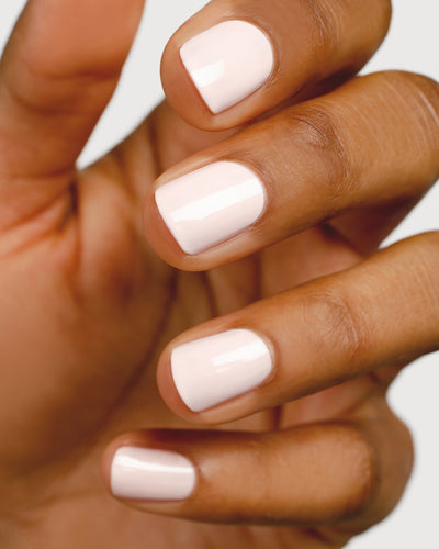 rosewater pink nail polish hand swatch on medium skin tone up close