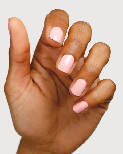 Cherry blossom pink nail polish hand swatch on medium skin tone