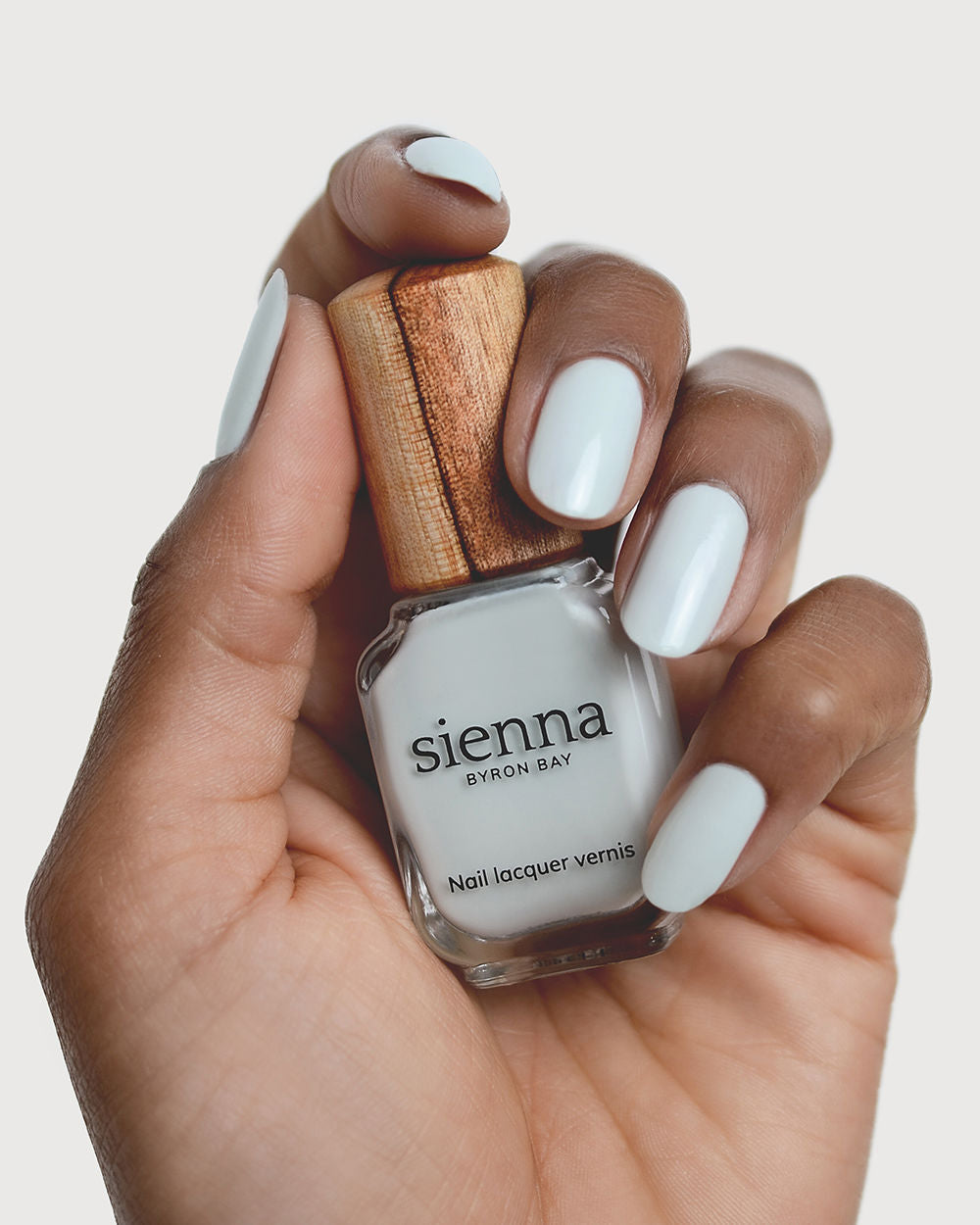 soft sage nail polish hand swatch on medium skin tone