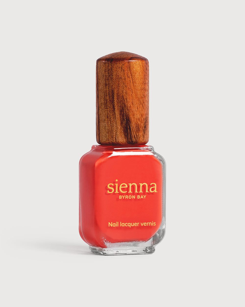 Warm strawberry red nail polish glass bottle with timber cap