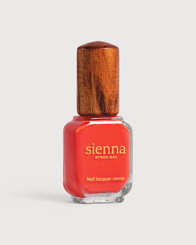 Warm strawberry red nail polish glass bottle with timber cap