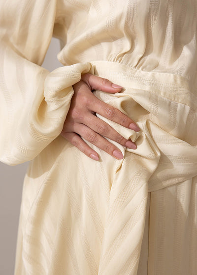 Womans hand on hip wearing Rosie creme non-toxic nail polish by Sienna Byron Bay, wearing cream thick dress