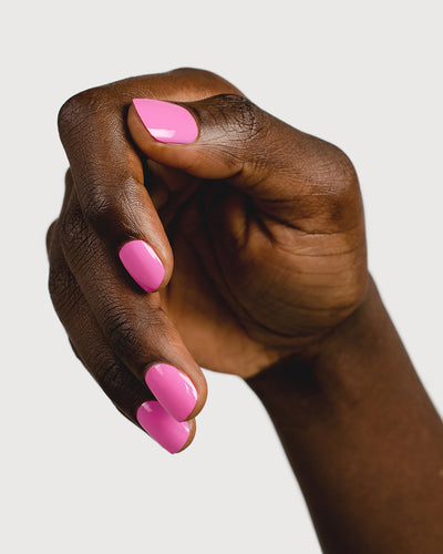 Bright mid-tone fuchsia nail polish hand swatch on dark skin tone