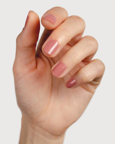 Stony mauve nail polish hand swatch on fair skin tone.