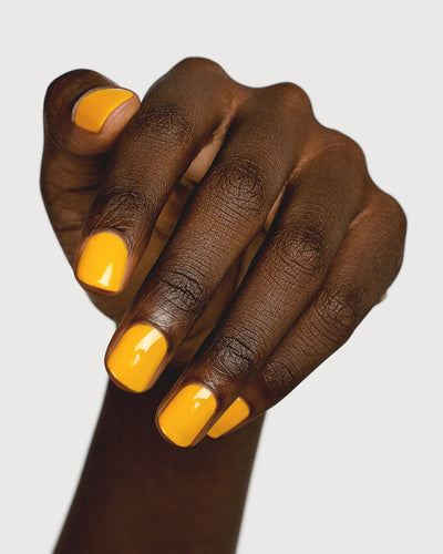 Sunflower yellow nail polish hand swatch on dark skin tone