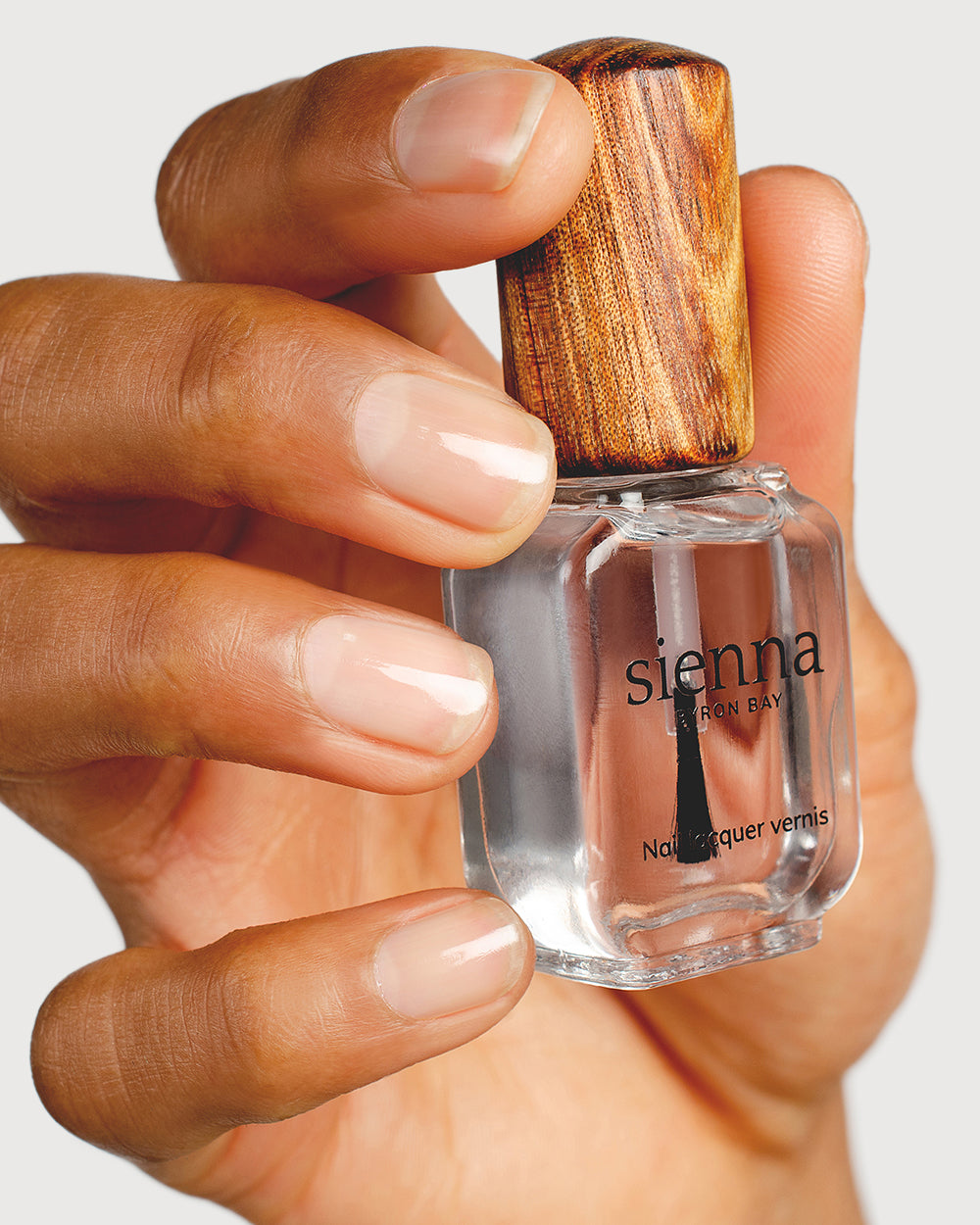 top coat nail polish hand swatch on medium skin tone up close