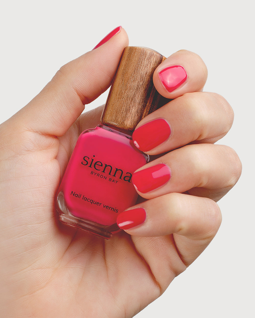 Blooming Fuchsia Petal Pink Nail Polish on Fair Skin Tone with Bottle